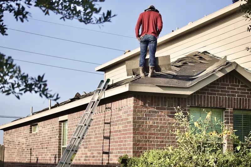 Professional roofer working on a residential roof in Finleyville